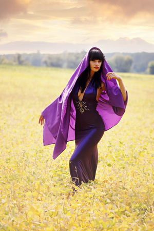 women in a purple cloak in fieldの写真素材