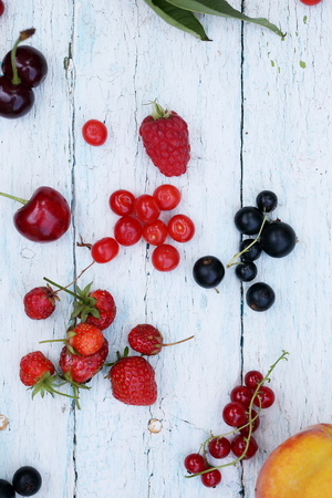 garden organic berries and fruits on white wooden backgroundの写真素材