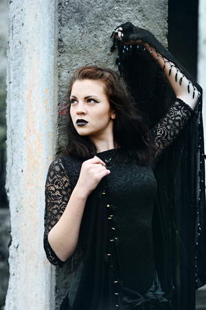 Young modern beautiful witch in the black shawlの写真素材