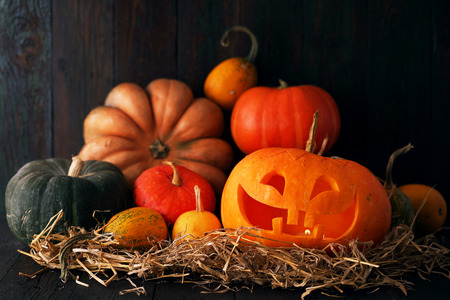 Halloween pumpkin head jack lantern on wooden backgroundの写真素材