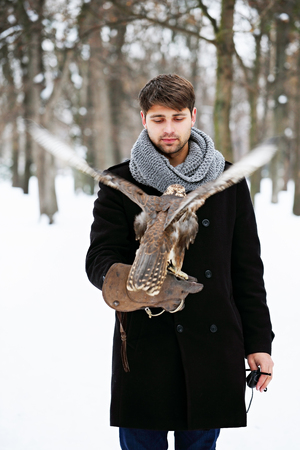 man holding a falcon
