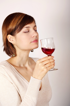 Young woman tasting pink wine