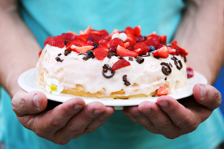 Cake in mens handsの写真素材