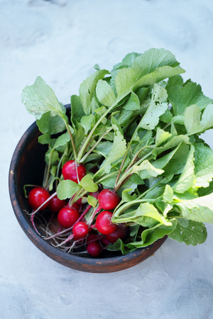Radish in a wooden bowlの写真素材