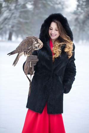 woman and falcon in winterの写真素材