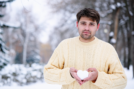 Handsome guy holding the heartの写真素材