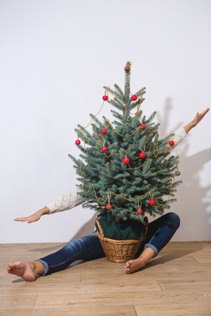 The girl behind the Christmas treeの写真素材