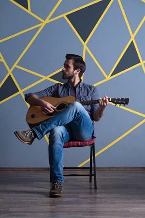 young handsome man with guitarの写真素材