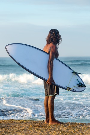 Surfer on the shore with a boardの写真素材