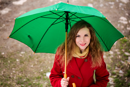 Cheerful woman under an umbrellaの写真素材