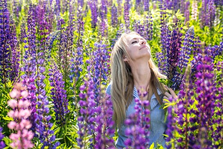 A girl is enjoys flowersの写真素材
