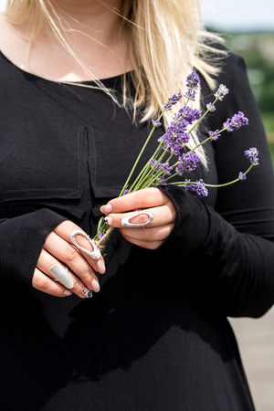 Hands holding a bouquet of lavenderの写真素材