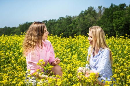 Cheerful girls on a yellow fieldの写真素材