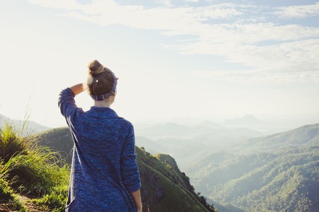 girl tourist at the top of the mountain in the rays of dawn, Sri Lankaの写真素材