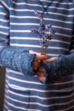 The girl in woolen gloves without fingersの写真素材