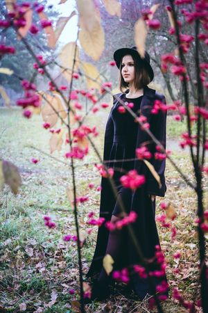woman in a black coat on the roadの写真素材