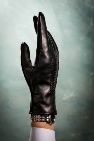 Hand in classic black leather gloveの写真素材