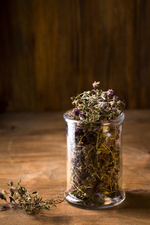 Dry flowers of thyme in a glass jar