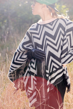 woman in poncho, hat and glovesの写真素材