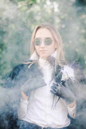 Beautiful stylish blonde in leather gloves and a fur jacket