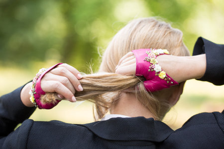 Girl in short pink gloves with embroidery