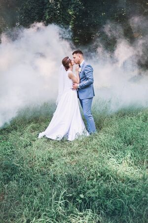 beautiful romantic couple in love amid white smokeの写真素材