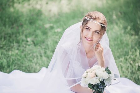 Young beautiful girl in wedding dress and veilの写真素材