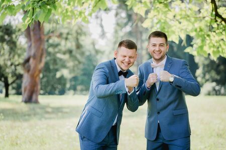 Groom and friend of the groom at a wedding in the parkの写真素材