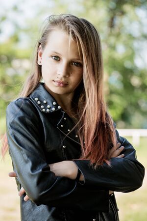 Beautiful brutal teen girl with pink hair and leather jacketの写真素材
