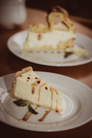 Cheesecake with caramel, mint and raspberries on the table