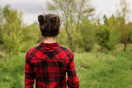 A young girl with a hair horns goes on the meadow