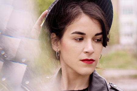 Beautiful girl in a black hat. Photos with highlight