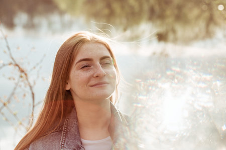 Portrait of a young beautiful redhead woman with freckles