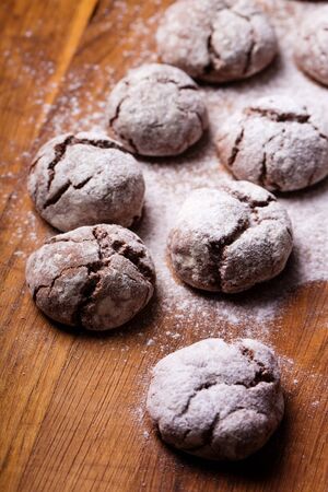 marble cookies on a wooden table sprinkled with icing sugarの写真素材