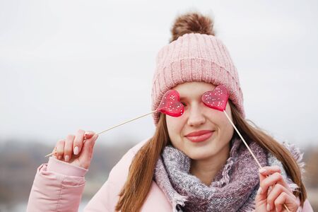 Beautiful girl holds a lollipop. The concept for St. Valentine's Dayの写真素材