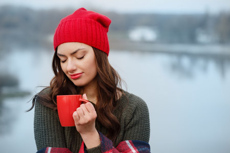 Girl drinks coffee from a red cup