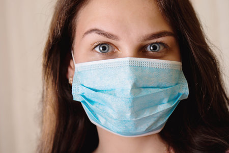 Young beautiful girl in a protective bandage on her face