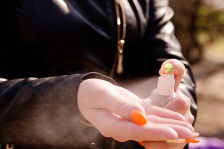 Young woman handles hands with an antiseptic. Coronavirus Protection Conceptの写真素材