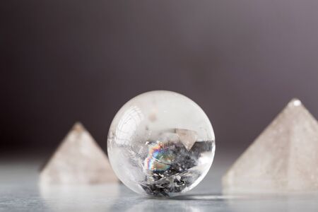crystal ball and rock crystal pyramid against a dark background, Reiki conceptの写真素材