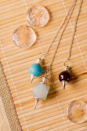 Pendulums for working in a reiki stream and signs of the second stage of a reiki on rock crystal