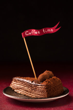 Spartacus multilayer chocolate cake on a burgundy background