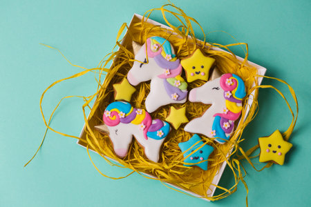 Beautiful, bright, figured gingerbread cookies for the holiday in a gift box on a turquoise...