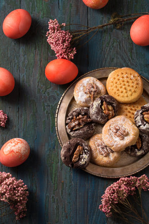 Easter still life homemade cookies colored eggs and flowersの写真素材