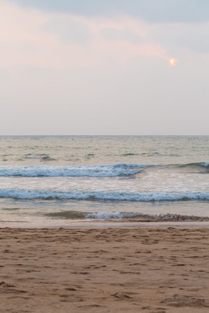 Beautiful gentle pink sunset by the ocean, summer backgroundの写真素材