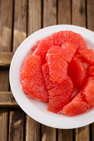 Juicy delicious ripe grapefruit on a plateの写真素材