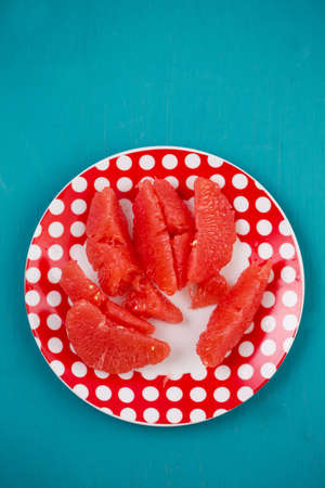 Juicy delicious ripe grapefruit on a plateの写真素材