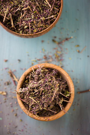 Dry herb Oregano for medicinal tea in a wooden bowl