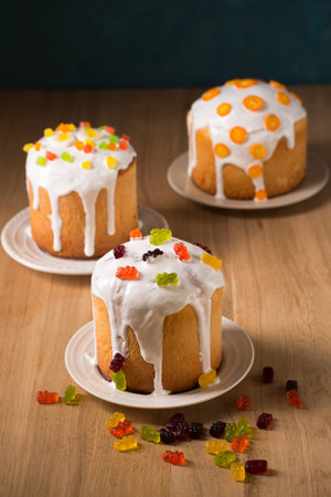 Easter cakes decorated with candied fruits and jelly eggs, close-up