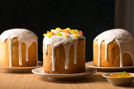 Three ruddy Easter cakes with white glaze on a dark background