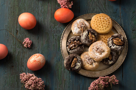 Easter nut cookies with colored eggs and pink flowers